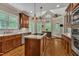 Gourmet kitchen with island, stainless appliances, and abundant natural light at 124 Mantle Dr, Clayton, NC 27527