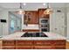 Spacious kitchen island featuring granite countertops, dark wood cabinets, and modern stainless steel appliances at 124 Mantle Dr, Clayton, NC 27527