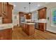 Modern kitchen featuring granite countertops, stainless steel appliances, and island cooktop at 124 Mantle Dr, Clayton, NC 27527
