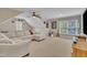 Large living room features a big sofa, a ceiling fan, and lots of natural light at 124 Mantle Dr, Clayton, NC 27527