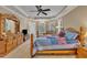 Primary bedroom features a tray ceiling, carpet floors, a ceiling fan, a television, and natural lighting at 124 Mantle Dr, Clayton, NC 27527