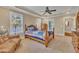 Spacious primary bedroom features a tray ceiling, carpet flooring, and natural light from large windows at 124 Mantle Dr, Clayton, NC 27527