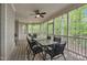 Inviting screened patio with ceiling fans, ample seating, and views of the lush, natural surroundings at 124 Mantle Dr, Clayton, NC 27527