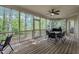 Screened patio featuring a ceiling fan, a dining table for six, and views of the outdoors at 124 Mantle Dr, Clayton, NC 27527
