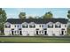 Well maintained exterior elevation showcasing garages and black trimmed windows on a sunny day at 125 Holton St, Smithfield, NC 27577