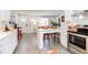 Open concept view of modern kitchen leading to living area with breakfast bar seating at 1309 Hudson Ave # D9, Durham, NC 27705