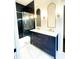 Elegant bathroom with black tiled shower, marble countertop, and modern fixtures at 1310 Pender St, Raleigh, NC 27610