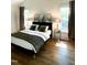 Bright bedroom with hardwood floors, natural light, and stylish decor at 1310 Pender St, Raleigh, NC 27610