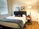 Comfortable bedroom featuring a plush bed, hardwood floors, and stylish decor at 1310 Pender St, Raleigh, NC 27610