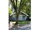 Charming blue single-story home with a well-manicured lawn and mature trees offering great curb appeal at 1310 Pender St, Raleigh, NC 27610