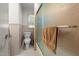 Cozy bathroom featuring a toilet, shower with glass door, and wainscoting at 1329 Mebane St, Burlington, NC 27217