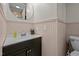 Powder room featuring a modern round mirror and a black vanity with white sink at 1329 Mebane St, Burlington, NC 27217