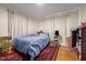 Simple bedroom with wood floors, large red rug, and natural light at 1329 Mebane St, Burlington, NC 27217