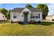 Charming, light and airy single-story home with neutral colors and well-manicured lawn and flowerbeds at 1329 Mebane St, Burlington, NC 27217