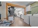 Open kitchen and laundry room with white appliances, wood accents, ample counter space, and hardwood floors at 1329 Mebane St, Burlington, NC 27217