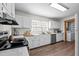 White kitchen featuring stainless steel appliances, ample counter space, and hardwood floors at 1329 Mebane St, Burlington, NC 27217