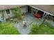 The backyard has a patio, covered carport, and green grass, with a glimpse of the red car at 133 Montree Ln, Graham, NC 27253