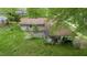 Aerial view of the backyard, patio, carport, trees, and green grass surrounding a house at 133 Montree Ln, Graham, NC 27253