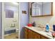 Bathroom featuring a shower-tub combo, vanity sink, medicine cabinet, and purple walls at 133 Montree Ln, Graham, NC 27253