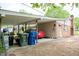 Carport showcasing a red car, storage, and an attached brick house at 133 Montree Ln, Graham, NC 27253