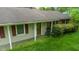 Close-up of the front exterior with a glass paneled door and red shutters on the windows at 133 Montree Ln, Graham, NC 27253