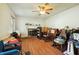 Comfortable living room with hardwood floors, a ceiling fan, a fireplace, and bright natural light at 133 Montree Ln, Graham, NC 27253