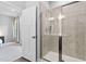 Modern bathroom with glass shower, tiled walls, and an open doorway at 139 Callowhill Ln, Durham, NC 27713