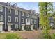 Townhome with gray siding, multiple windows, dormers and light green doors at 139 Callowhill Ln, Durham, NC 27713