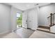 Bright foyer with light grey vinyl flooring, white walls, and stairs to the right at 139 Callowhill Ln, Durham, NC 27713
