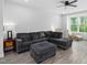 Comfortable living room with gray sectional sofa and ample natural light at 139 Callowhill Ln, Durham, NC 27713