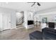 Open living area with stairs, TV area, dining table, and kitchen with island at 139 Callowhill Ln, Durham, NC 27713