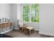 Cozy reading nook with chair, ottoman, and shelving near bright windows at 139 Callowhill Ln, Durham, NC 27713