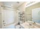 A full bathroom with a shower-tub combo, vanity, and tiled floors at 140 Cedar Elm Rd, Durham, NC 27713