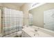 Neutral bathroom featuring a single sink vanity, toilet, and shower with striped curtain at 140 Cedar Elm Rd, Durham, NC 27713