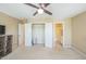 Bedroom offering neutral walls, a ceiling fan, television with console, and ensuite bathroom access at 140 Cedar Elm Rd, Durham, NC 27713