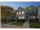 Charming townhome with cozy front yard and warm exterior lighting at dusk at 140 Cedar Elm Rd, Durham, NC 27713