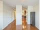 Hallway view towards kitchen featuring hardwood floors and white trim at 140 Cedar Elm Rd, Durham, NC 27713