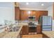 Well-appointed kitchen with stainless steel appliances, granite counters, and ample cabinet space at 140 Cedar Elm Rd, Durham, NC 27713