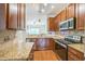 Updated kitchen boasts granite countertops, modern appliances, and a view to the living space at 140 Cedar Elm Rd, Durham, NC 27713
