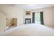Light-filled living room with a fireplace and access to the outdoor patio through sliding glass doors at 140 Cedar Elm Rd, Durham, NC 27713
