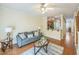 Open living room with hardwood floors, a ceiling fan, and seamless access to the kitchen at 140 Cedar Elm Rd, Durham, NC 27713