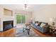 Comfortable living room featuring a fireplace, ceiling fan, and sliding doors to the outside at 140 Cedar Elm Rd, Durham, NC 27713