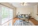 Cozy living room featuring a sliding glass door, fan, hardwood floors, and neutral tones at 140 Cedar Elm Rd, Durham, NC 27713