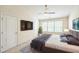 Cozy main bedroom featuring neutral walls, ceiling fan and a TV for relaxing enjoyment at 140 Cedar Elm Rd, Durham, NC 27713