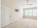 A spacious main bedroom has neutral walls, ceiling fan, large windows, and carpeted flooring at 140 Cedar Elm Rd, Durham, NC 27713