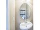 Simple powder room featuring a pedestal sink and an oval mirror over the sink at 140 Cedar Elm Rd, Durham, NC 27713