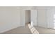 Bedroom with neutral carpet and paint; doorway leads to another room at 144 Global Ave, Fuquay Varina, NC 27526
