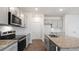 A close view of the kitchen's stainless steel appliances and granite countertops at 144 Global Ave, Fuquay Varina, NC 27526