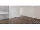 Living space with wood-look flooring, with gray cabinets and granite countertops in view at 144 Global Ave, Fuquay Varina, NC 27526