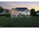 Landscaped backyard featuring a patio, screened porch, fire pit, and string lights at 149 Country Mill Way, Fuquay Varina, NC 27526